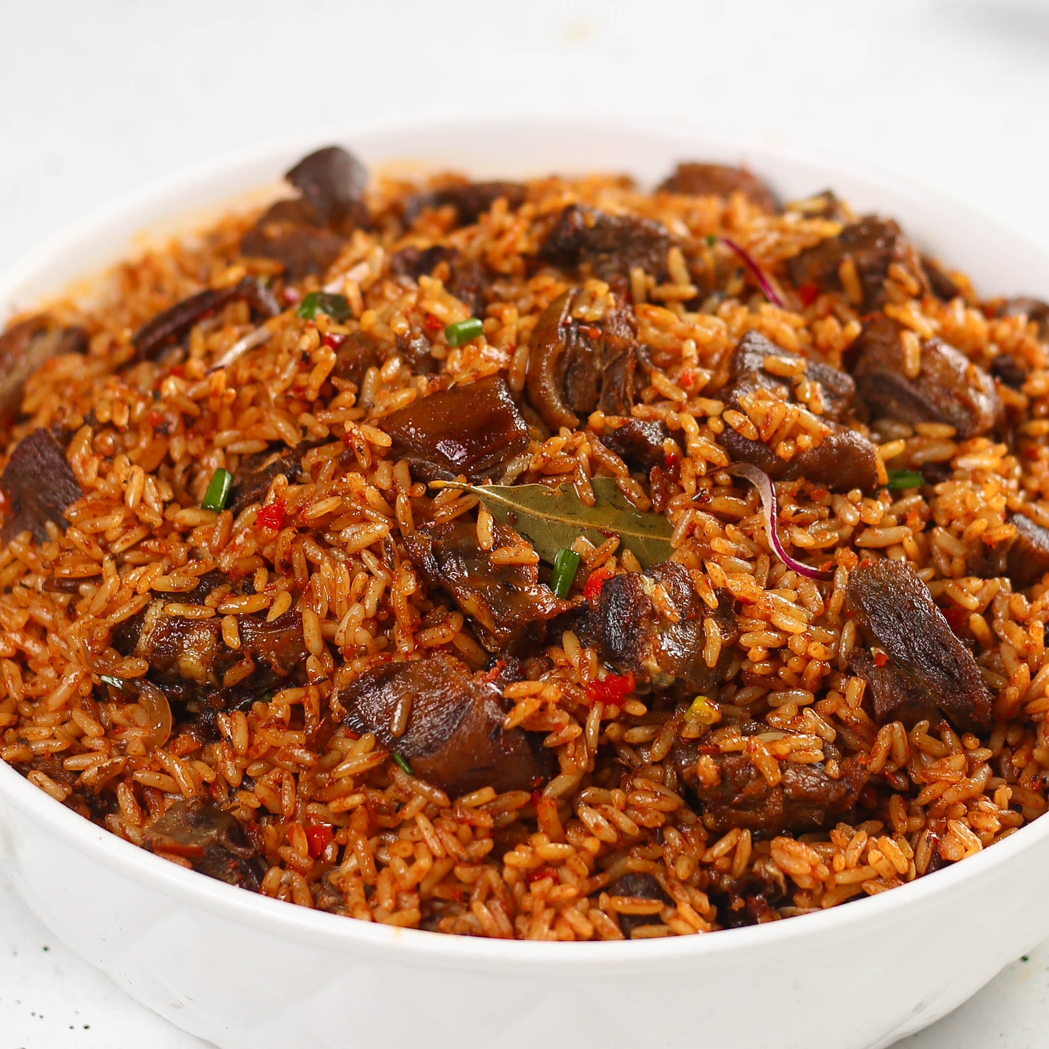 Asun rice topped with spiced goat meat